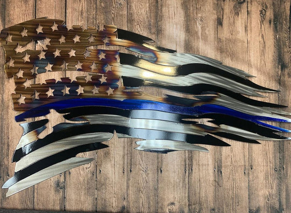 Handcrafted Tattered Thin Blue Line Flag with unique color finish on a rustic wooden background.