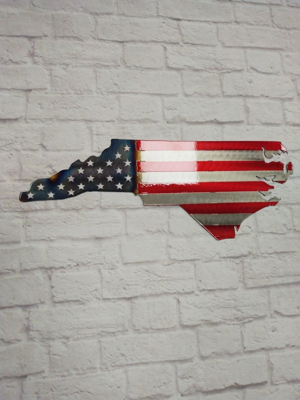 Handcrafted state-shaped flag of North Carolina with red and blue stripes and stars, showcasing unique laser-cut design.
